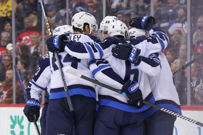 Mar 7, 2025; Newark, New Jersey, USA; Winnipeg Jets left wing Alex Iafallo (9) celebrates his goal against the New Jersey Devils during the first period at Prudential Center. Mandatory Credit: Ed Mulholland-Imagn Images