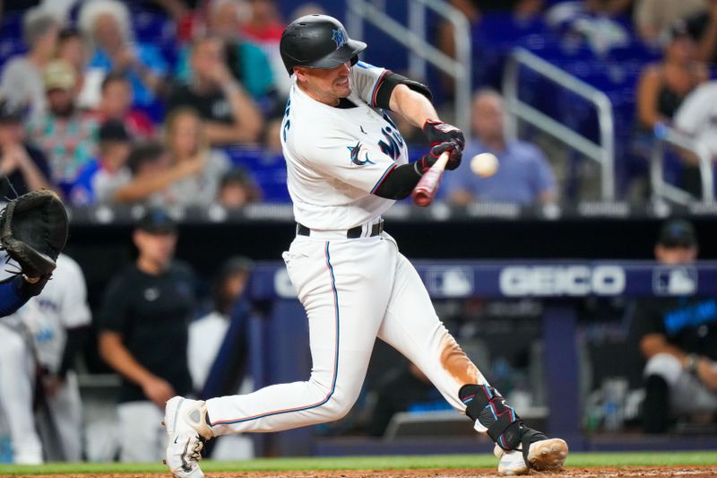 Sep 17, 2023; Miami, Florida, USA; Miami Marlins catcher Nick Fortes (4) hits a double against the Atlanta Braves during the sixth inning at loanDepot Park. Mandatory Credit: Rich Storry-USA TODAY Sports