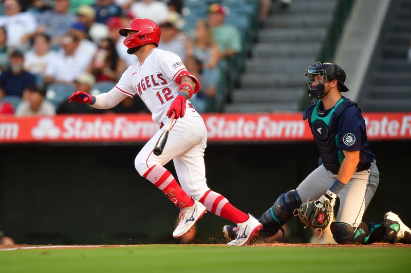 Jul 11, 2024; Anaheim, California, USA; Los Angeles Angels right fielder Kevin Pillar (12) hits a single against the Seattle Mariners during the first inning at Angel Stadium. Mandatory Credit: Gary A. Vasquez-USA TODAY Sports