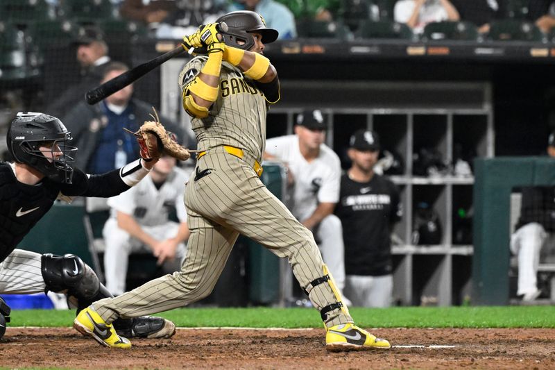 Sep 20, 2025; Chicago, Illinois, USA;  San Diego Padres first baseman Luis Arraez (4) hits an RBI single against the Chicago White Sox during the ninth inning at Rate Field. Mandatory Credit: Matt Marton-Imagn Images