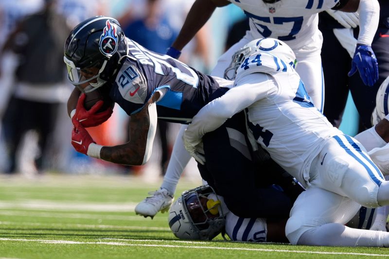 Tennessee Titans running back Tony Pollard (20) is tackled by Indianapolis Colts' Zaire Franklin (44) during the first half of an NFL football game, Sunday, Oct. 13, 2024, in Nashville, Tenn. (AP Photo/George Walker IV)