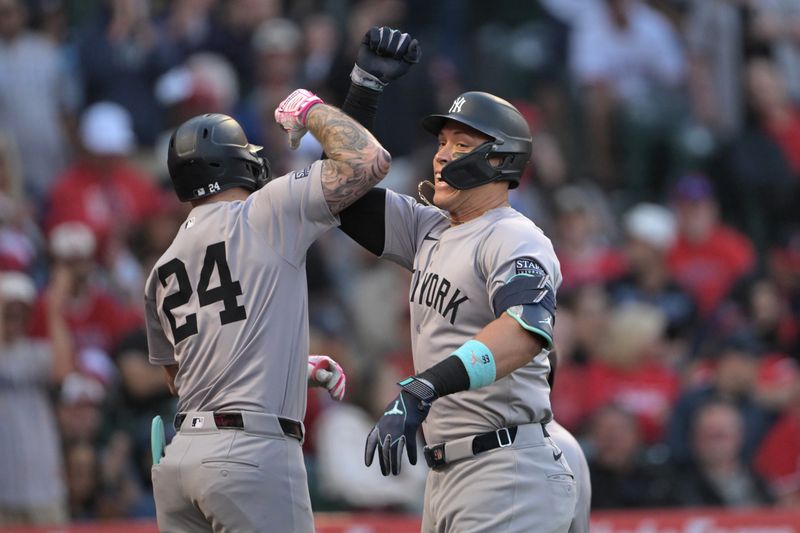 May 30, 2024; Anaheim, California, USA;  New York Yankees center fielder Aaron Judge (99) is congratulated by left fielder Alex Verdugo (24) after hitting a two-run home run in the fourth inning against the Los Angeles Angels at Angel Stadium. Mandatory Credit: Jayne Kamin-Oncea-USA TODAY Sports