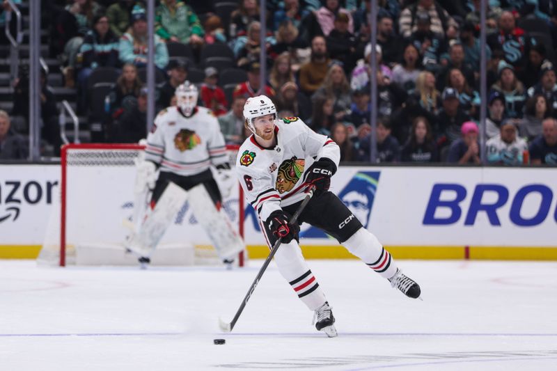 Nov 3, 2025; Seattle, Washington, USA; Chicago Blackhawks defenseman Sam Rinzel (6) looks to pass in the first period against the Seattle Kraken at Climate Pledge Arena. Mandatory Credit: Kevin Ng-Imagn Images