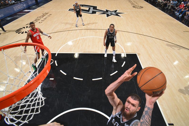 SAN ANTONIO, TX - MARCH 12: Sandro Mamukelashvili #54 of the San Antonio Spurs  drives to the basket during the game against the Houston Rockets on March 12, 2024 at the Frost Bank Center in San Antonio, Texas. NOTE TO USER: User expressly acknowledges and agrees that, by downloading and or using this photograph, user is consenting to the terms and conditions of the Getty Images License Agreement. Mandatory Copyright Notice: Copyright 2024 NBAE (Photos by Jesse D. Garrabrant/NBAE via Getty Images)