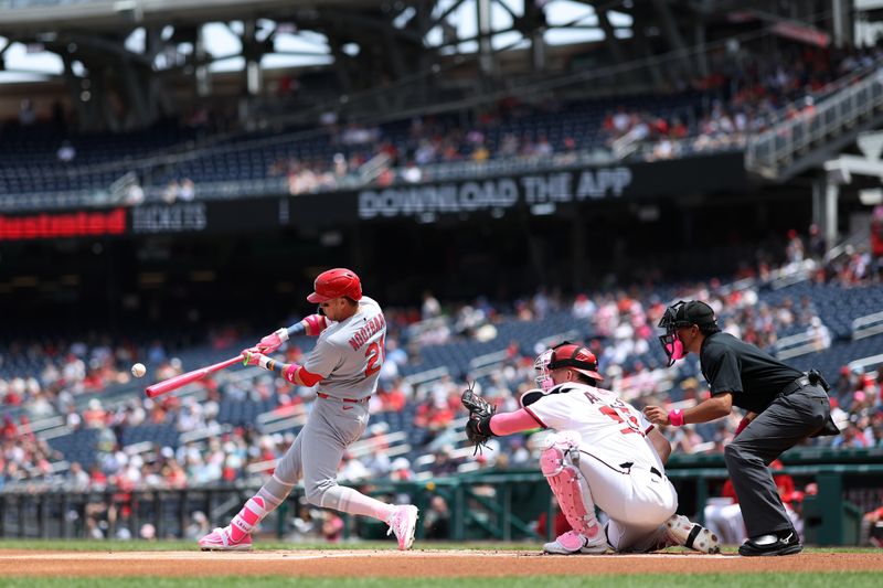 May 11, 2025; Washington, District of Columbia, USA; St. Louis Cardinals outfielder Lars Nootbaar (21) hits a solo home run against the Washington Nationals during the first inning at Nationals Park. Mandatory Credit: Geoff Burke-Imagn Images