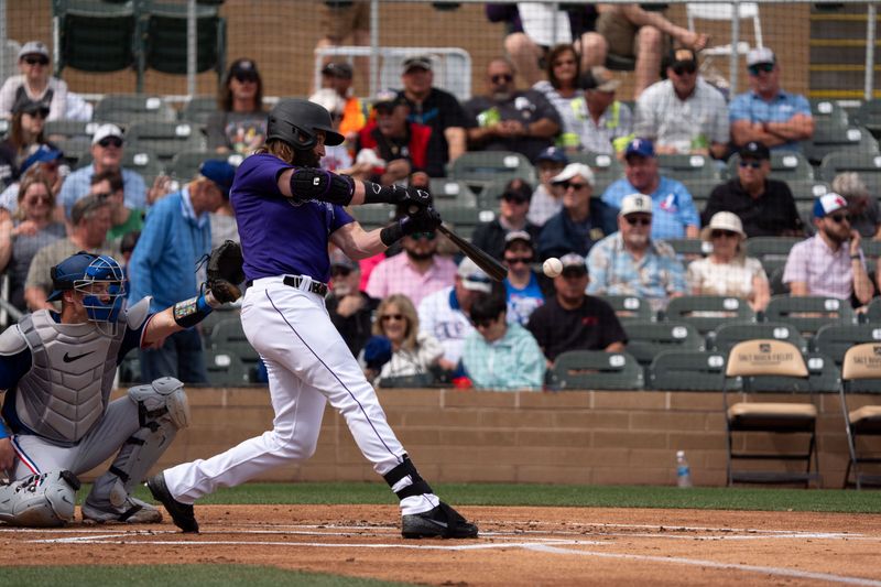 Mar 6, 2024; Salt River Pima-Maricopa, Arizona, USA; Colorado Rockies designated hitter Charlie Blackmon (19) singles in the first during a spring training game against  the Texas Rangers at Salt River Fields at Talking Stick. Mandatory Credit: Allan Henry-USA TODAY Sports