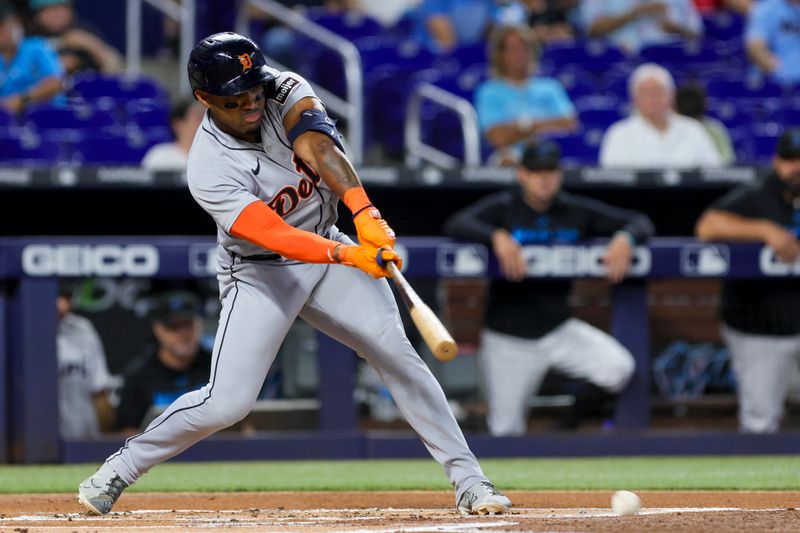 Jul 30, 2023; Miami, Florida, USA; Detroit Tigers second baseman Andy Ibanez (77) singles against the Miami Marlins during the first inning at loanDepot Park. Mandatory Credit: Sam Navarro-USA TODAY Sports