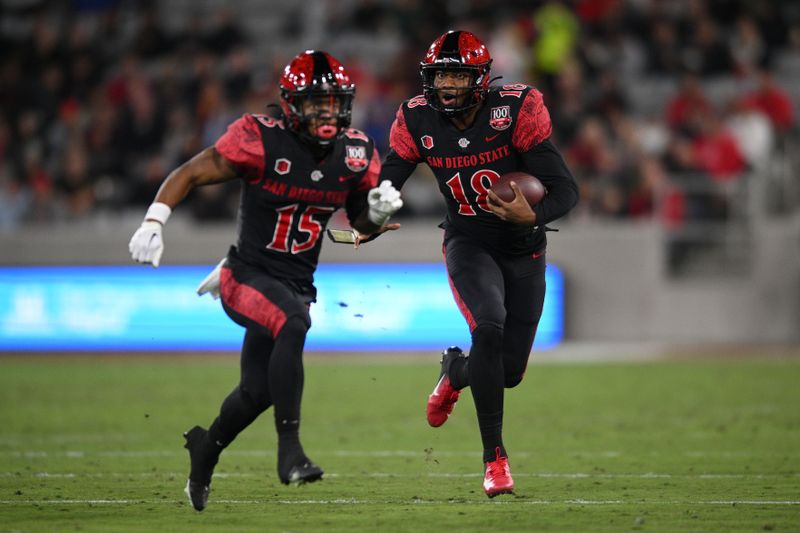 Nov 26, 2022; San Diego, California, USA; San Diego State Aztecs quarterback Jalen Mayden (18) runs with the ball behind running back Jordan Byrd (15) during the first half against the Air Force Falcons at Snapdragon Stadium. Mandatory Credit: Orlando Ramirez-USA TODAY Sports