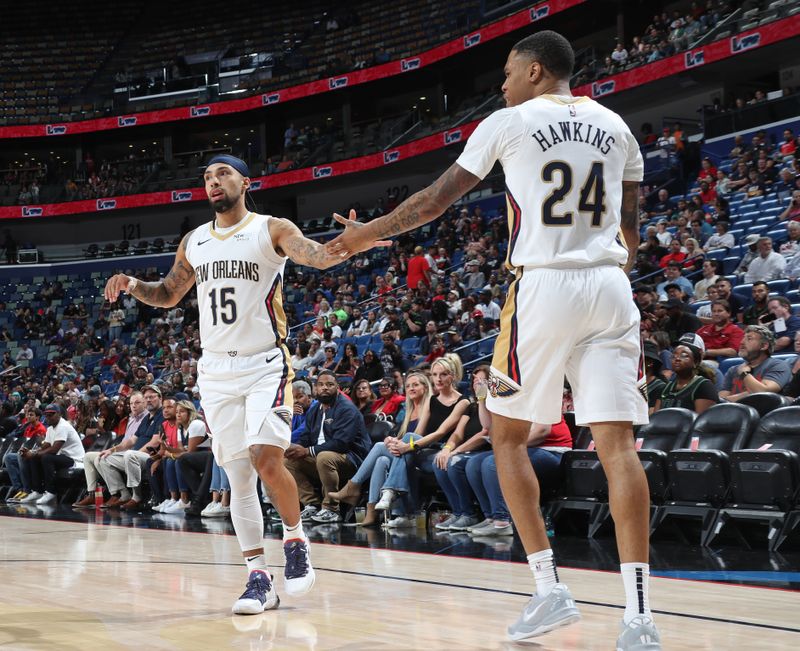 NEW ORLEANS, LA - OCTOBER 7: Jose Alvarado #15 shake hadst with Jordan Hawkins #24 of the New Orleans Pelicans during the game against the Orlando Magic on October 7, 2024 at the Smoothie King Center in New Orleans, Louisiana. NOTE TO USER: User expressly acknowledges and agrees that, by downloading and or using this Photograph, user is consenting to the terms and conditions of the Getty Images License Agreement. Mandatory Copyright Notice: Copyright 2024 NBAE (Photo by Layne Murdoch Jr./NBAE via Getty Images)