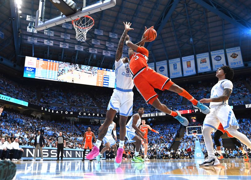 Jan 13, 2024; Chapel Hill, North Carolina, USA;  Syracuse Orange guard Judah Mintz (3) shoots as North Carolina Tar Heels forward Armando Bacot (5) defends in the first half at Dean E. Smith Center. Mandatory Credit: Bob Donnan-USA TODAY Sports