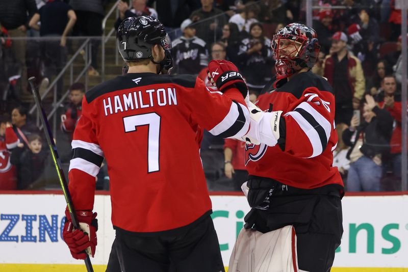 Dec 6, 2024; Newark, New Jersey, USA; New Jersey Devils defenseman Dougie Hamilton (7) and goaltender Jacob Markstrom (25) celebrate their win over the Seattle Kraken  at Prudential Center. Mandatory Credit: Ed Mulholland-Imagn Images