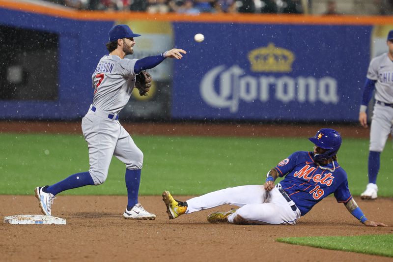 Aug 7, 2023; New York City, New York, USA; Chicago Cubs shortstop Dansby Swanson (7) forces out New York Mets second baseman Jonathan Arauz (19) at second base and throws to first to complete a double play during the sixth inning at Citi Field. Mandatory Credit: Vincent Carchietta-USA TODAY Sports