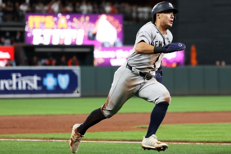 Sep 20, 2025; Baltimore, Maryland, USA; New York Yankees shortstop Anthony Volpe (11) scores during the sixth inning against the Baltimore Orioles at Oriole Park at Camden Yards. Mandatory Credit: Daniel Kucin Jr.-Imagn Images