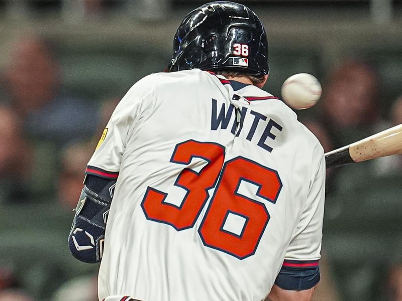 May 13, 2025; Cumberland, Georgia, USA; Atlanta Braves left fielder Eli White (36) is hit by a pitch against the Washington Nationals during the eighth inning at Truist Park. Mandatory Credit: Dale Zanine-Imagn Images