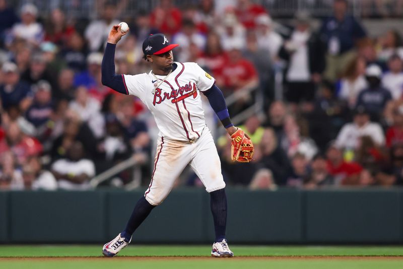 Apr 10, 2025; Atlanta, Georgia, USA; Atlanta Braves second baseman Ozzie Albies (1) throws a runner out aft first against the Philadelphia Phillies in the sixth inning at Truist Park. Mandatory Credit: Brett Davis-Imagn Images

