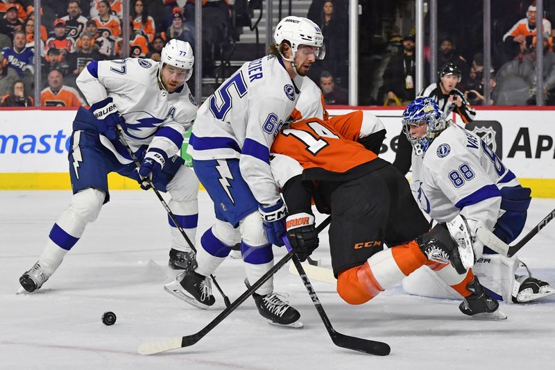 Feb 27, 2024; Philadelphia, Pennsylvania, USA; Tampa Bay Lightning defenseman Maxwell Crozier (65) battles with Philadelphia Flyers center Sean Couturier (14) during the first period at Wells Fargo Center. Mandatory Credit: Eric Hartline-USA TODAY Sports