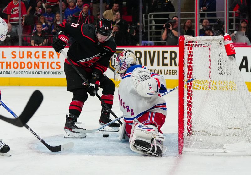 Mar 12, 2024; Raleigh, North Carolina, USA; New York Rangers goaltender Igor Shesterkin (31) stops the shot in close by Carolina Hurricanes left wing Jake Guentzel (59) during the third period at PNC Arena. Mandatory Credit: James Guillory-USA TODAY Sports