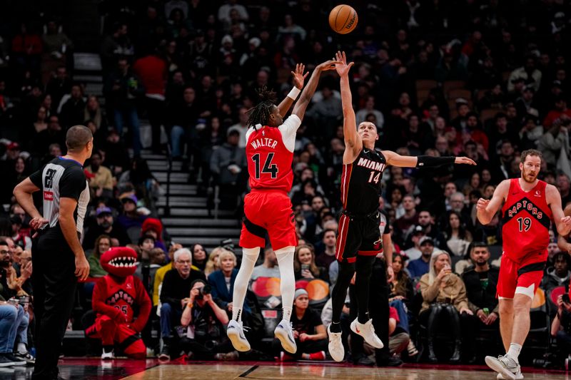 TORONTO, ON - DECEMBER 1: Ja'Kobe Walter #14 of the Toronto Raptors shoots the ball against Tyler Herro #14 of the Miami Heat at Scotiabank Arena on December 1, 2024 in Toronto, Ontario, Canada. NOTE TO USER: User expressly acknowledges and agrees that, by downloading and/or using this Photograph, user is consenting to the terms and conditions of the Getty Images License Agreement. (Photo by Andrew Lahodynskyj/Getty Images)