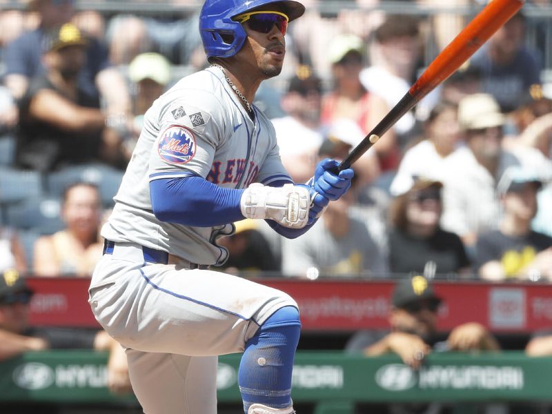 Jul 7, 2024; Pittsburgh, Pennsylvania, USA;  New York Mets shortstop Francisco Lindor (12) hits a double against  the Pittsburgh Pirates during the sixth inning at PNC Park. The Mets won 3-2. Mandatory Credit: Charles LeClaire-USA TODAY Sports