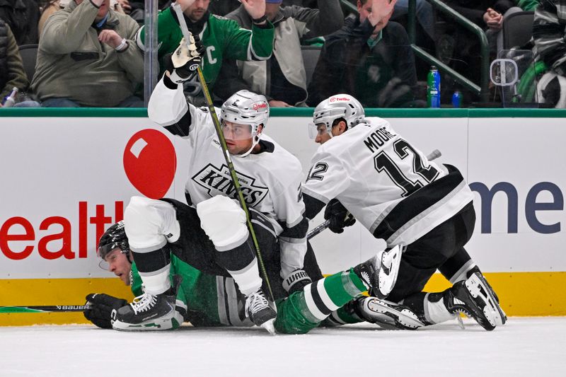 Dec 15, 2025; Dallas, Texas, USA; Los Angeles Kings defenseman Brian Dumoulin (2) and left wing Trevor Moore (12) sit on Dallas Stars right wing Mikko Rantanen (96) during the second period at the American Airlines Center. Mandatory Credit: Jerome Miron-Imagn Images