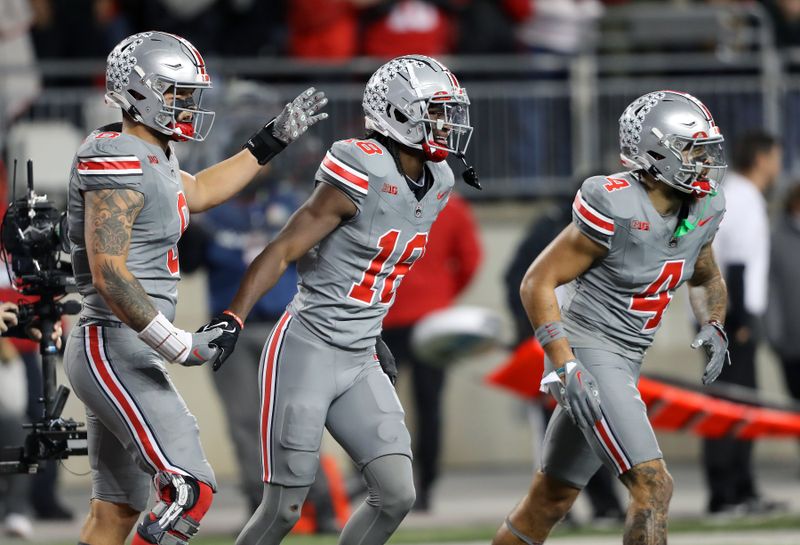 Nov 11, 2023; Columbus, Ohio, USA;  Ohio State Buckeyes wide receiver Marvin Harrison Jr. (18) celebrates the touchdown with tight end Cade Stover (8) and wide receiver Julian Fleming (4) during the first quarter against the Michigan State Spartans at Ohio Stadium. Mandatory Credit: Joseph Maiorana-USA TODAY Sports