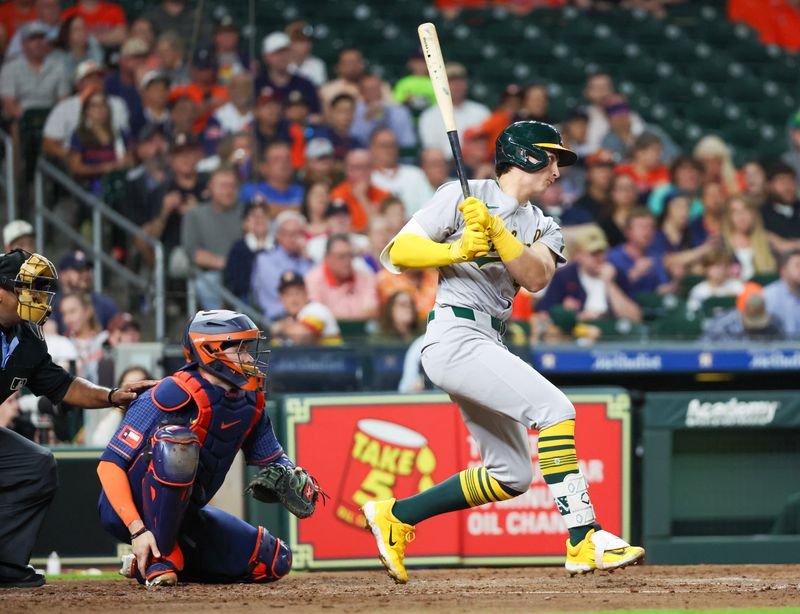 May 13, 2024; Houston, Texas, USA; Oakland Athletics first baseman Tyler Soderstrom (21) hits a RBI single agains the Houston Astros in the fourth inning at Minute Maid Park. Mandatory Credit: Thomas Shea-USA TODAY Sports