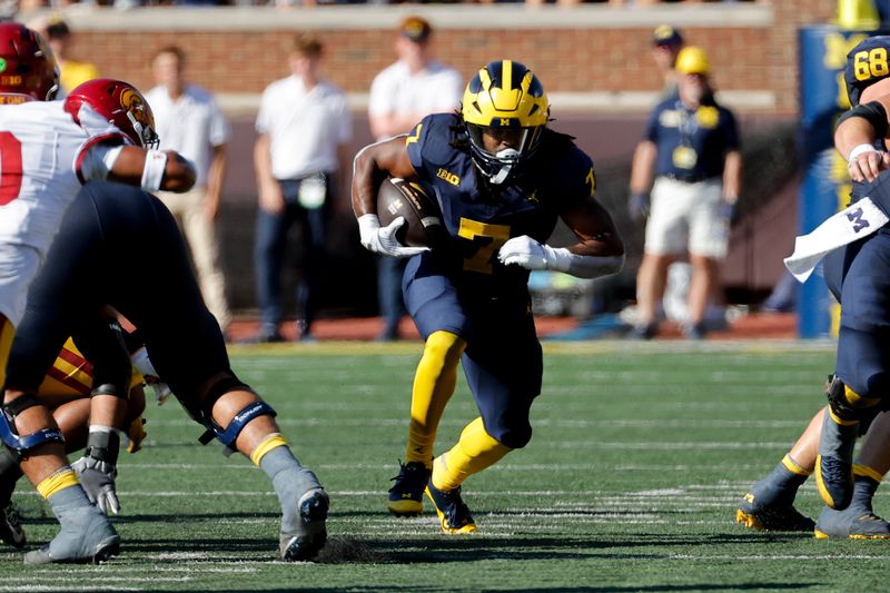 Sep 21, 2024; Ann Arbor, Michigan, USA;  Michigan Wolverines running back Donovan Edwards (7) rushes in the first half against the USC Trojans at Michigan Stadium. Mandatory Credit: Rick Osentoski-Imagn Images
