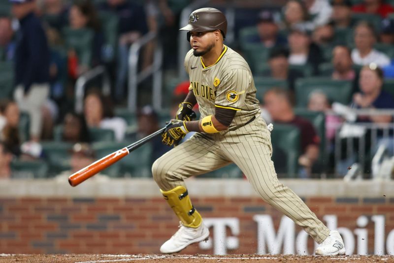 May 17, 2024; Atlanta, Georgia, USA; San Diego Padres second baseman Luis Arraez (4) hits a single against the Atlanta Braves in the fifth inning at Truist Park. Mandatory Credit: Brett Davis-USA TODAY Sports