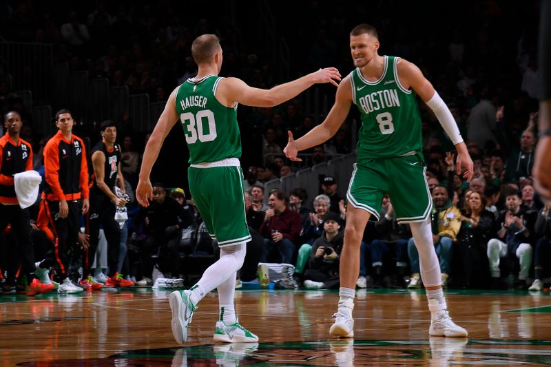 BOSTON, MA - DECEMBER 4: Sam Hauser #30 and Kristaps Porzingis #8 of the Boston Celtics high five during the game against the Detroit Pistons on December 4, 2024 at TD Garden in Boston, Massachusetts. NOTE TO USER: User expressly acknowledges and agrees that, by downloading and/or using this Photograph, user is consenting to the terms and conditions of the Getty Images License Agreement. Mandatory Copyright Notice: Copyright 2024 NBAE (Photo by Brian Babineau/NBAE via Getty Images)