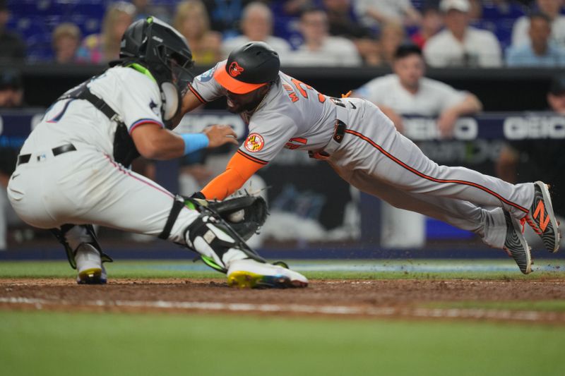 Jul 25, 2024; Miami, Florida, USA;  Miami Marlins catcher Ali Sánchez (47) tags out Baltimore Orioles outfielder Cedric Mullins (31) in the 10th inning at loanDepot Park. Mandatory Credit: Jim Rassol-USA TODAY Sports