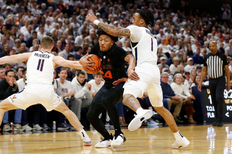 Feb 5, 2024; Charlottesville, Virginia, USA; Miami (Fl) Hurricanes guard Nijel Pack (24) controls the ball as Virginia Cavaliers guard Dante Harris (1) and Cavaliers guard Isaac McKneely (11) defend during the first half at John Paul Jones Arena. Mandatory Credit: Amber Searls-USA TODAY Sports