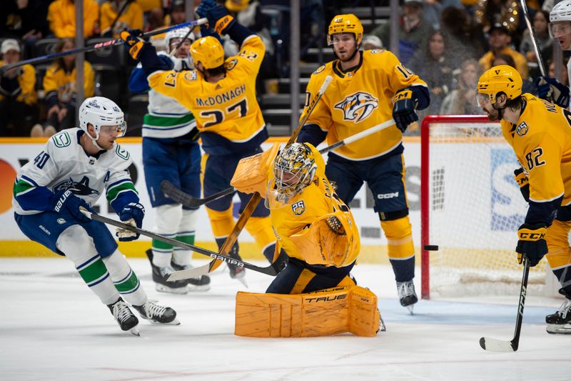 May 3, 2024; Nashville, Tennessee, USA; Nashville Predators goaltender Juuse Saros (74) blocks the shot of Vancouver Canucks defenseman Quinn Hughes (43) during the second period in game six of the first round of the 2024 Stanley Cup Playoffs at Bridgestone Arena. Mandatory Credit: Steve Roberts-USA TODAY Sports