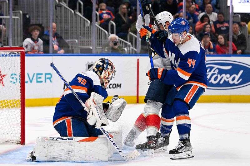 Jan 27, 2024; Elmont, New York, USA; New York Islanders center Jean-Gabriel Pageau (44) holds off Florida Panthers center Sam Reinhart (13) in front of New York Islanders goaltender Semyon Varlamov (40) during the third period at UBS Arena. Mandatory Credit: Dennis Schneidler-USA TODAY Sports