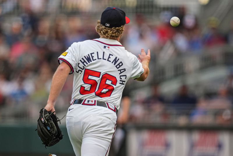 May 29, 2024; Cumberland, Georgia, USA; Atlanta Braves starting pitcher Spencer Schwellenbach (56) tosses the ball for a force out after fielding a ground ball against the Washington Nationals during the first inning at Truist Park. Mandatory Credit: Dale Zanine-USA TODAY Sports