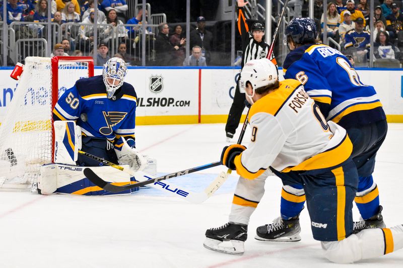 Mar 23, 2025; St. Louis, Missouri, USA;  St. Louis Blues goaltender Jordan Binnington (50) makes a save against Nashville Predators left wing Filip Forsberg (9) during the third period at Enterprise Center. Mandatory Credit: Jeff Curry-Imagn Images