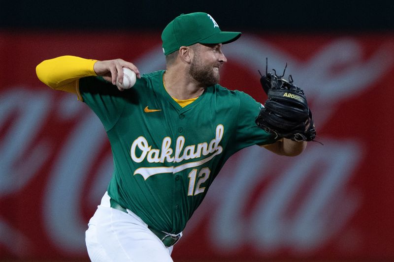 Aug 19, 2024; Oakland, California, USA; Oakland Athletics shortstop Max Schuemann (12) throws the baseball during the sixth inning against the Tampa Bay Rays at Oakland-Alameda County Coliseum. Mandatory Credit: Stan Szeto-USA TODAY Sports