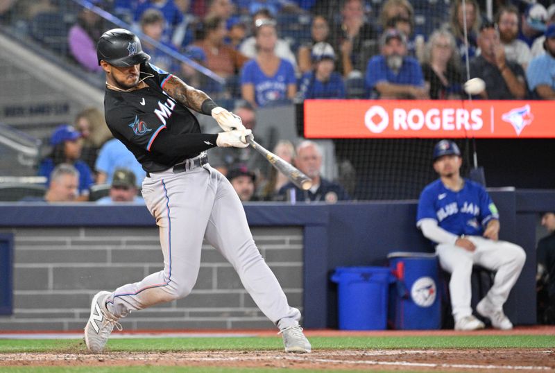 Sep 28, 2024; Toronto, Ontario, CAN; Miami Marlins center fielder Dane Myers (54) hits a three run home run against the Toronto Blue Jays in the eighth inning at Rogers Centre. Mandatory Credit: Dan Hamilton-Imagn Images