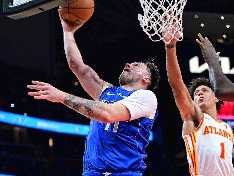 ATLANTA, GA - JANUARY 26: Luka Doncic #77 of the Dallas Mavericks drives to the basket during the game against the Atlanta Hawks on January 26, 2024 at State Farm Arena in Atlanta, Georgia.  NOTE TO USER: User expressly acknowledges and agrees that, by downloading and/or using this Photograph, user is consenting to the terms and conditions of the Getty Images License Agreement. Mandatory Copyright Notice: Copyright 2024 NBAE (Photo by Adam Hagy/NBAE via Getty Images)