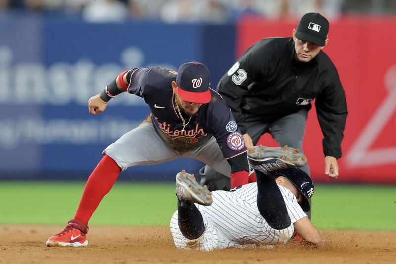 Aug 22, 2023; Bronx, New York, USA; Washington Nationals second baseman Ildemaro Vargas (14) tags out New York Yankees shortstop Anthony Volpe (11) trying to steal second base during the fourth inning at Yankee Stadium. Mandatory Credit: Brad Penner-USA TODAY Sports