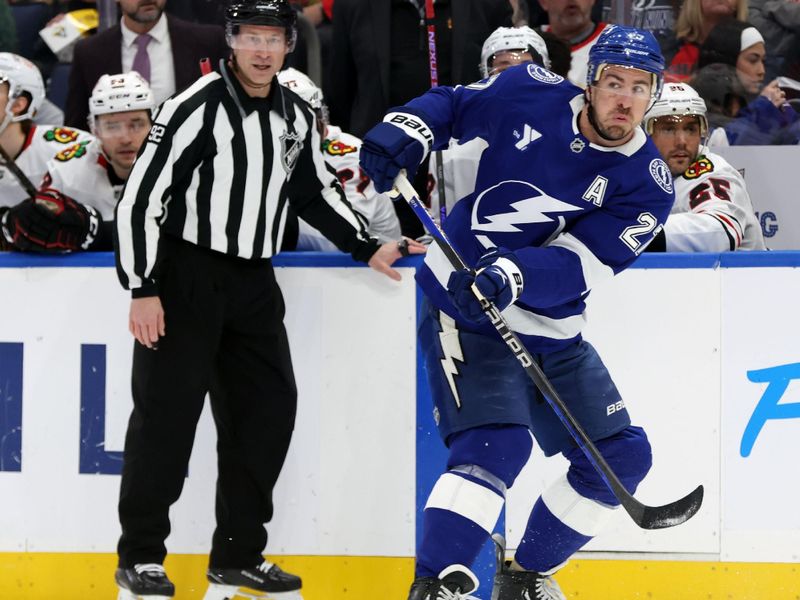 Jan 28, 2025; Tampa, Florida, USA; Tampa Bay Lightning defenseman Ryan McDonagh (27) passes the puck against the Chicago Blackhawks during the first period at Amalie Arena. Mandatory Credit: Kim Klement Neitzel-Imagn Images