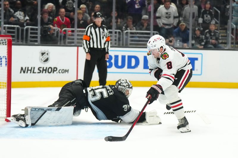 Nov 2, 2024; Los Angeles, California, USA; Chicago Blackhawks center Ryan Donato (8) shoots the puck against LA Kings goaltender Darcy Kuemper (35) for a goal in overtime at Crypto.com Arena. Mandatory Credit: Kirby Lee-Imagn Images