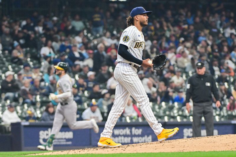 Jun 11, 2023; Milwaukee, Wisconsin, USA;  Milwaukee Brewers pitcher Freddy Peralta (51) reacts after giving up a 3-run home run to Oakland Athletes left fielder Seth Brown  in the fourth inning at American Family Field. Mandatory Credit: Benny Sieu-USA TODAY Sports