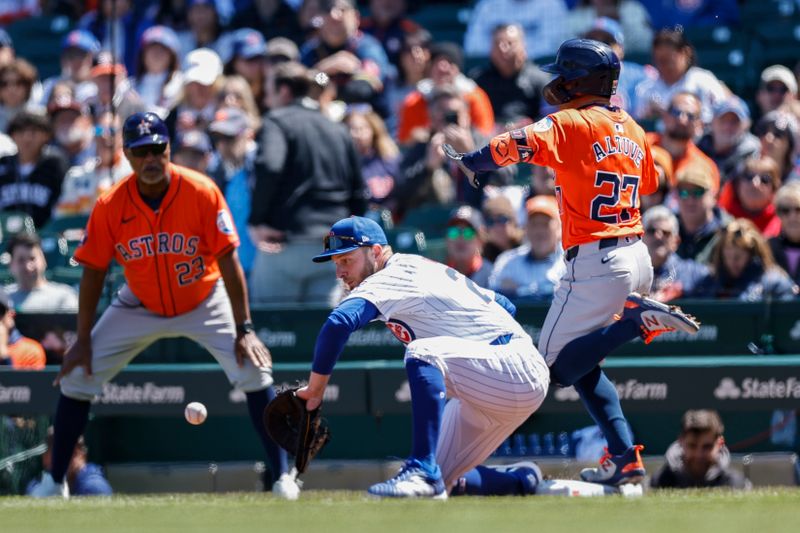 Apr 25, 2024; Chicago, Illinois, USA; Houston Astros second baseman Jose Altuve (27) beats Chicago Cubs first baseman Michael Busch (29) to first base after hitting a single against the during the first inning at Wrigley Field. Mandatory Credit: Kamil Krzaczynski-USA TODAY Sports