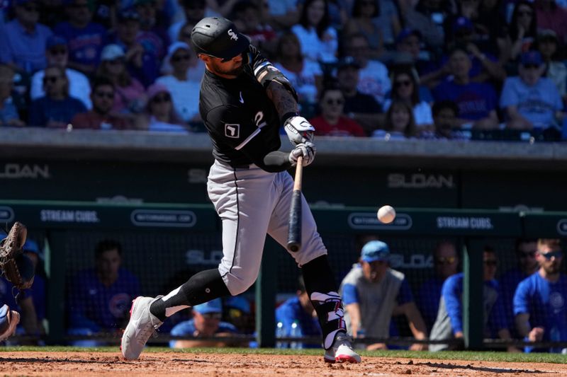 Mar 1, 2024; Mesa, Arizona, USA; Chicago White Sox right fielder Kevin Pillar (12) hits a double against the Chicago Cubs during the third inning at Sloan Park. Mandatory Credit: Rick Scuteri-USA TODAY Sports