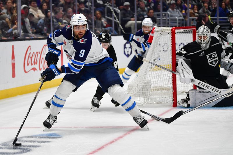 Dec 13, 2023; Los Angeles, California, USA; Winnipeg Jets left wing Alex Iafallo (9) moves the puck against the Los Angeles Kings during the third period at Crypto.com Arena. Mandatory Credit: Gary A. Vasquez-USA TODAY Sports