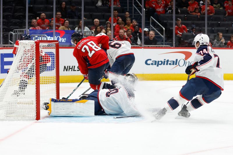 Sep 27, 2024; Washington, District of Columbia, USA; Columbus Blue Jackets goaltender Pavel Cajan (30) makes a save on Washington Capitals forward Andrew Cristell (28) in the third period at Capital One Arena. Mandatory Credit: Geoff Burke-Imagn Images