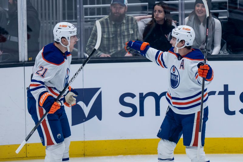 Dec 30, 2022; Seattle, Washington, USA; Edmonton Oilers forward Klim Kostin (21) is congratulated by forward Ryan Nugent-Hopkins (93) after scoring a goal during the first period against the Seattle Kraken at Climate Pledge Arena. Mandatory Credit: Stephen Brashear-USA TODAY Sports