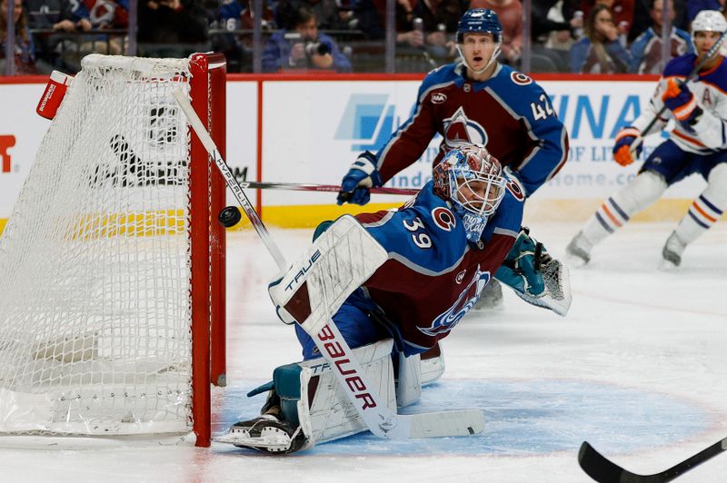 Jan 16, 2025; Denver, Colorado, USA; Colorado Avalanche goaltender Mackenzie Blackwood (39) defects the puck as defenseman Josh Manson (42) looks on in the first period against the Edmonton Oilers at Ball Arena. Mandatory Credit: Isaiah J. Downing-Imagn Images