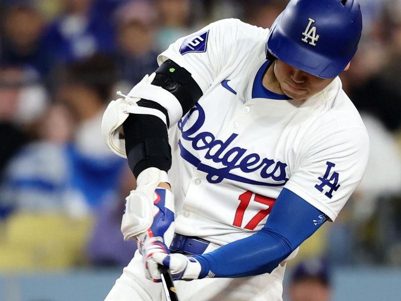 Jun 1, 2024; Los Angeles, California, USA;  Los Angeles Dodgers designated hitter Shohei Ohtani (17) hits a single during the seventh inning against the Colorado Rockies at Dodger Stadium. Mandatory Credit: Kiyoshi Mio-USA TODAY Sports