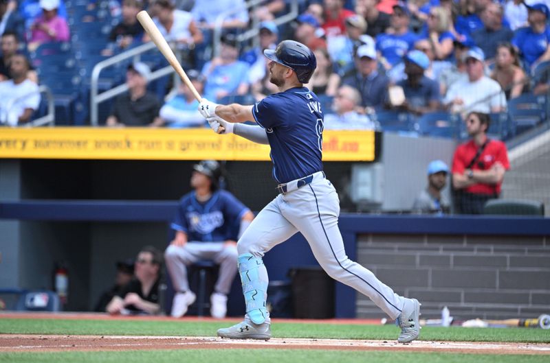 Jul 25, 2024; Toronto, Ontario, CAN; Tampa Bay Rays designated hitter Brandon Lowe (8) hits a solo home run in the first inning at Rogers Centre. Mandatory Credit: Dan Hamilton-USA TODAY Sports